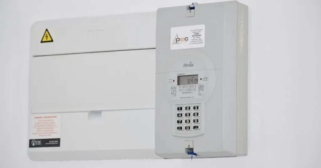 Electricity meter and fuse box mounted on a wall, representing utility bill payments