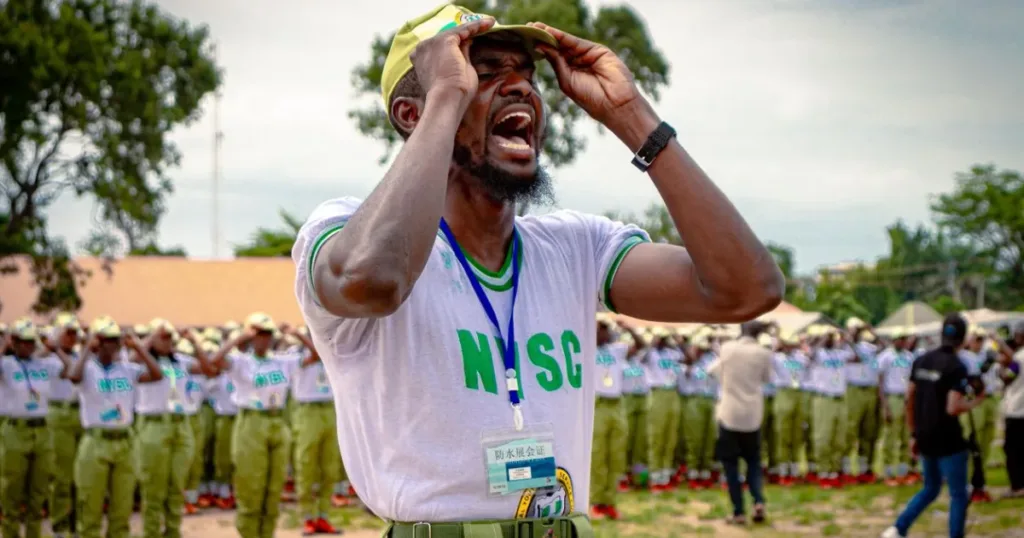 NYSC corps member leading an outdoor drill in Kaduna, representing the best money apps for NYSC members