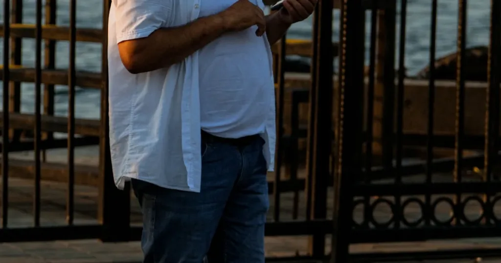 Person planning a 30 day financial checklist with notebook and phone