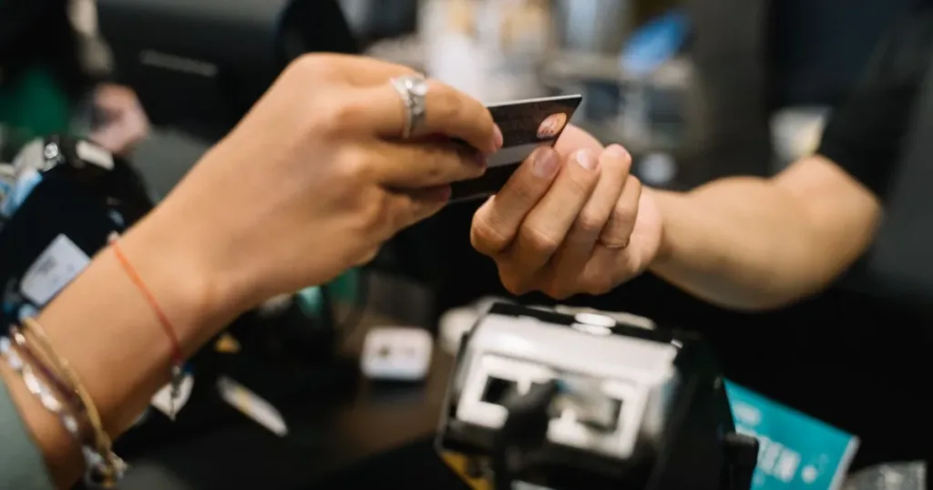 Woman holding a credit card while shopping online