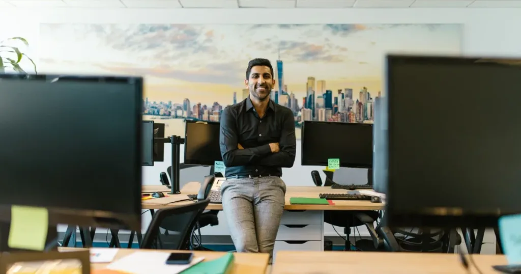 Smiling salaried professional in a modern Indian office