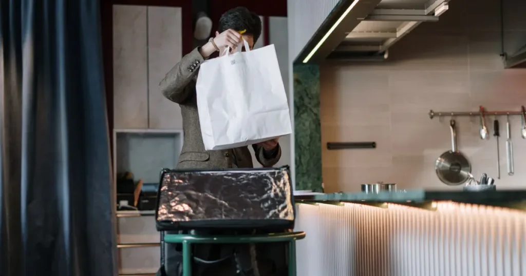 Grocery delivery bags packed with fresh produce at the door