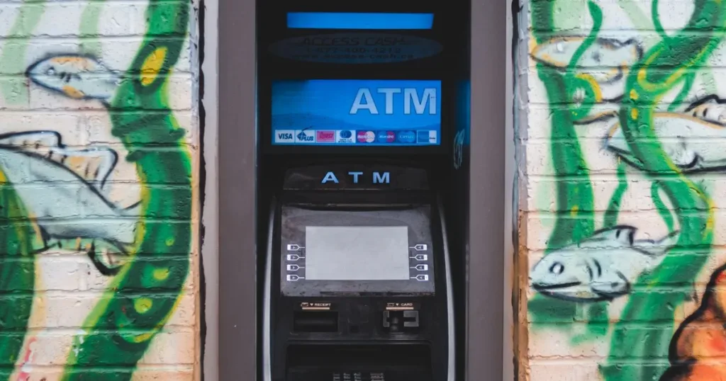 ATM machine on a colorful urban wall