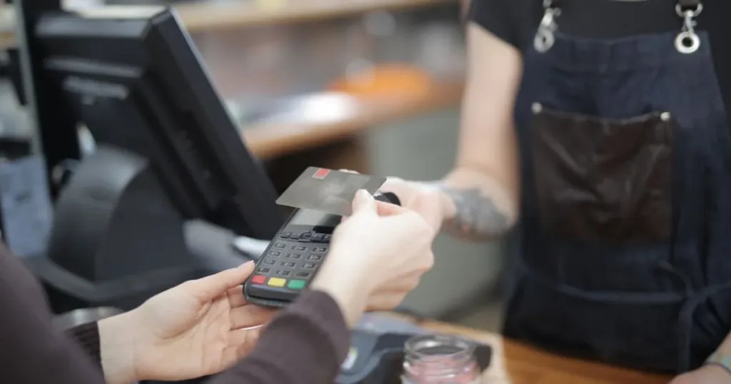 Close-up of customer and cashier during a credit card transaction