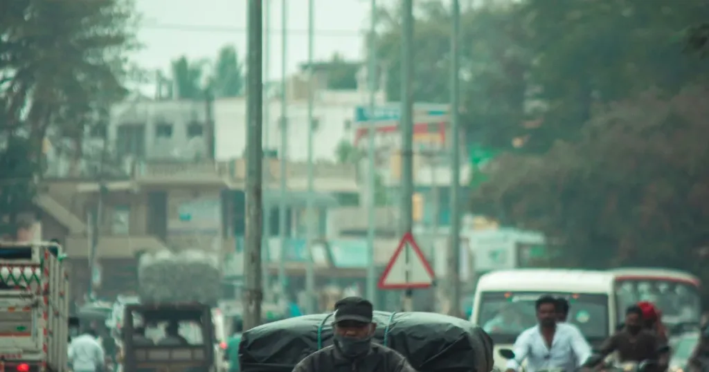 Delivery rider carrying goods on a motorcycle on an Indian road