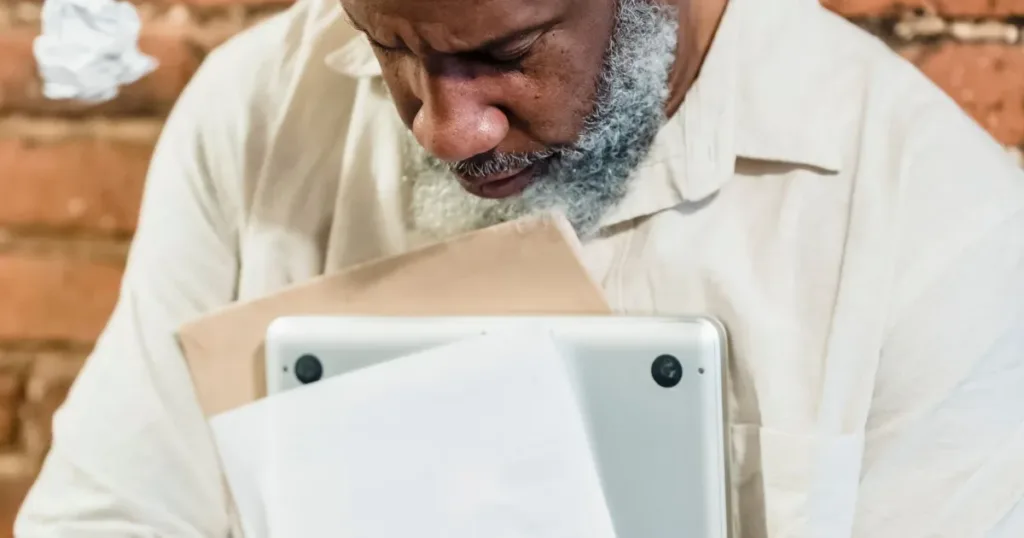Worried man reviewing his finances on a laptop