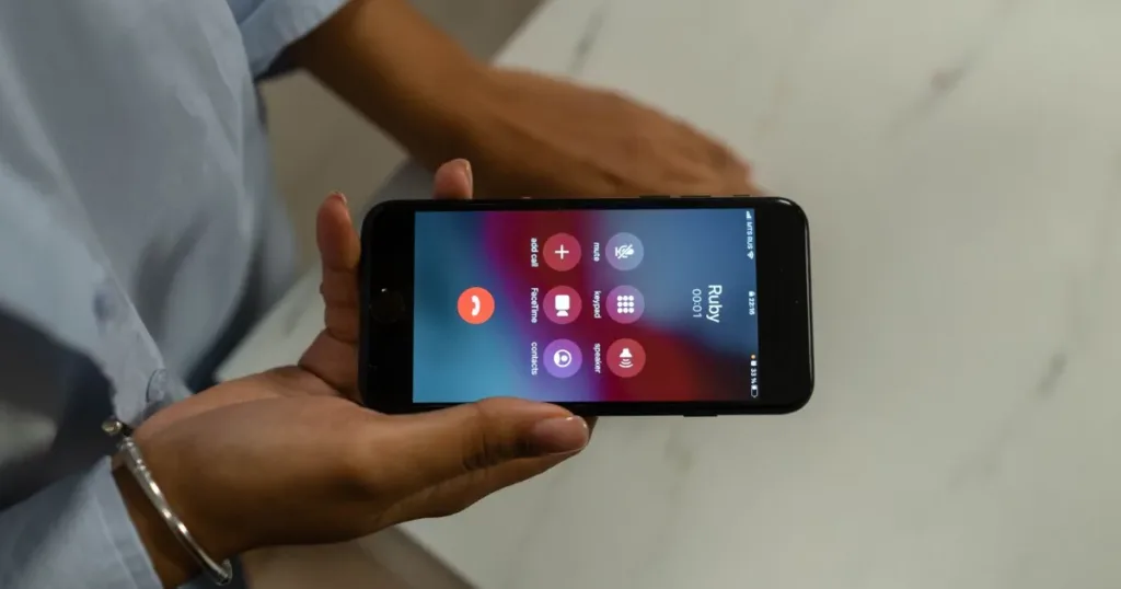 Person holding a smartphone showing an incoming unknown call