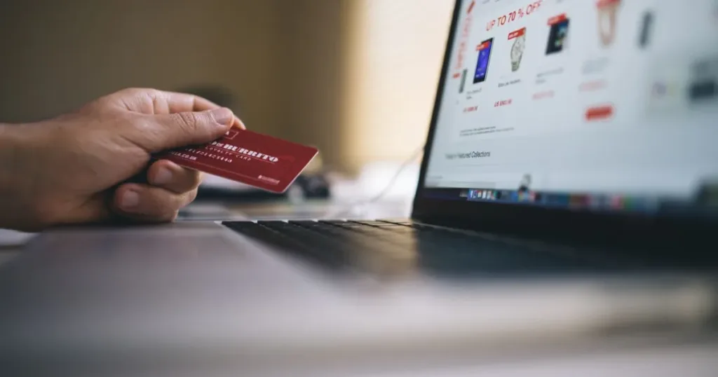 Woman making an online purchase using a credit card and laptop
