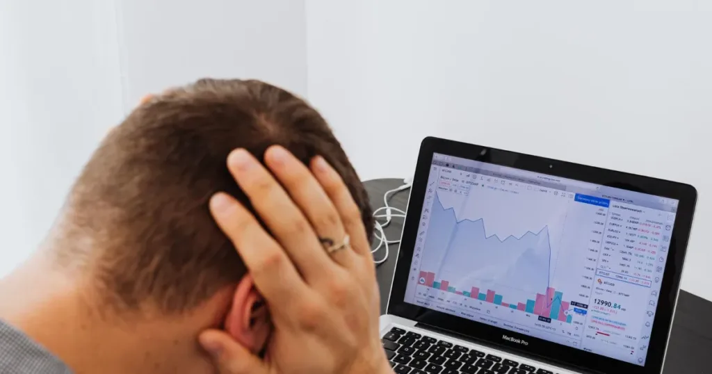 Man reviewing bills and payment history at a desk