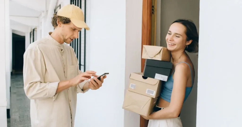 Woman receiving a delivery package at home in India