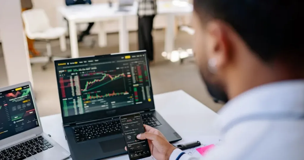 Young professional analyzing finances on a laptop in an office
