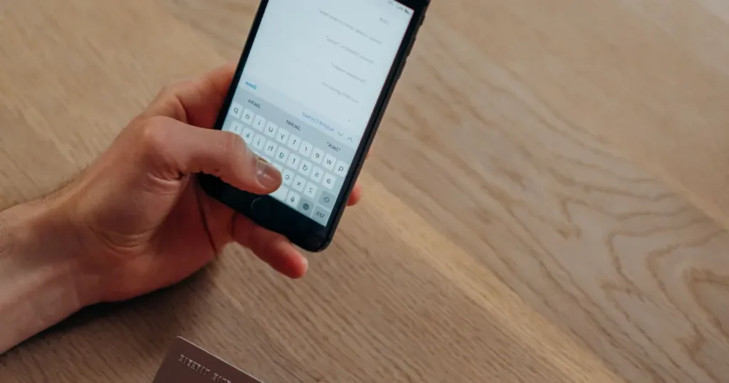 Hand holding a smartphone with a banking app open