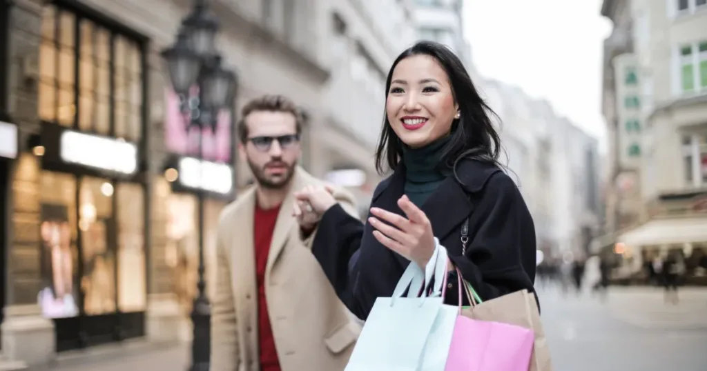 Person holding shopping bags after a satisfying shopping trip