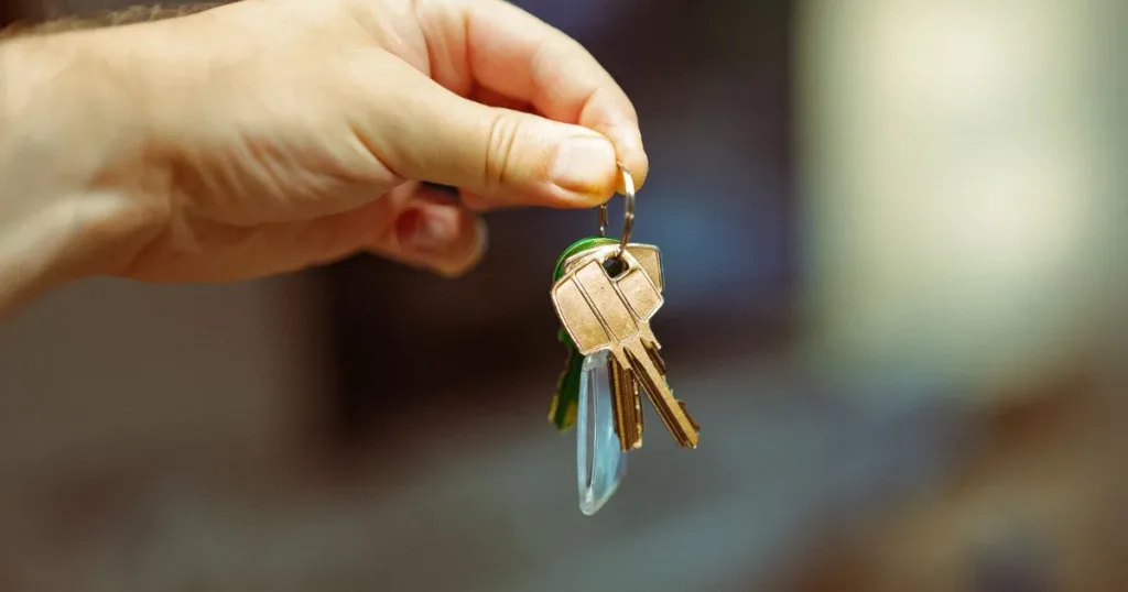 Apartment keys and door representing rental housing