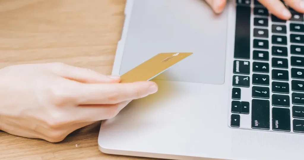 Woman making an online purchase using a credit card and laptop
