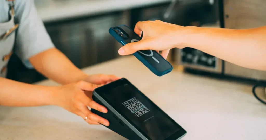 Close-up of a contactless payment using a smartphone and QR code