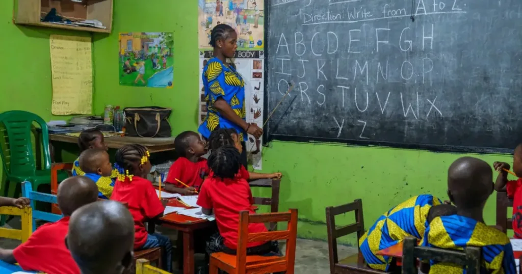 Young students learning together with a teacher in a classroom