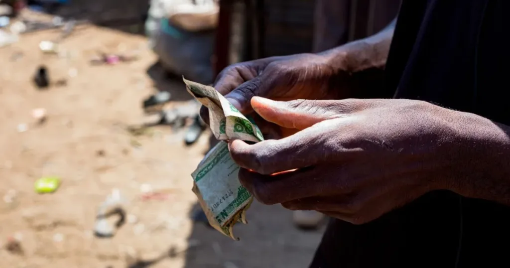 Hands counting Nigerian naira banknotes outdoors, representing cash and loan access in Nigeria