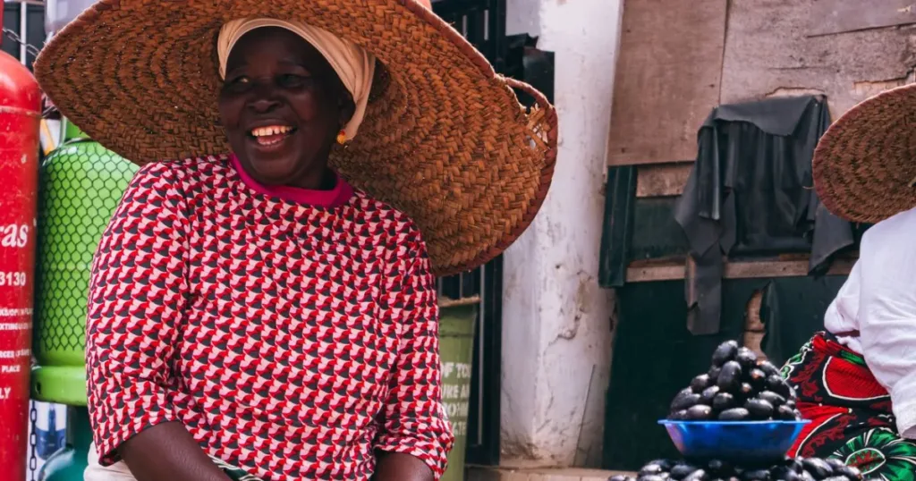 Smiling Nigerian market trader at her stall in Jos