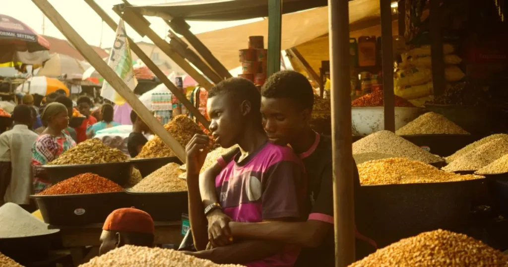 Bustling Lagos market with small business traders selling grains and spices