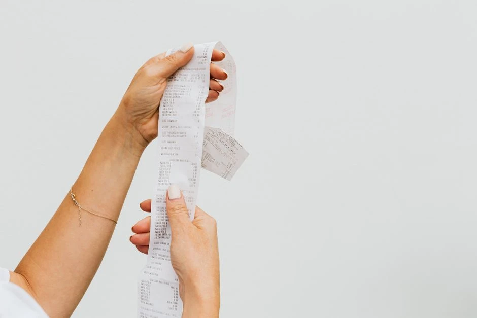 Woman comparing prices while grocery shopping on a budget