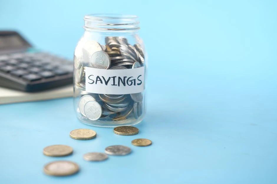 Coins saved in a glass jar for an emergency fund