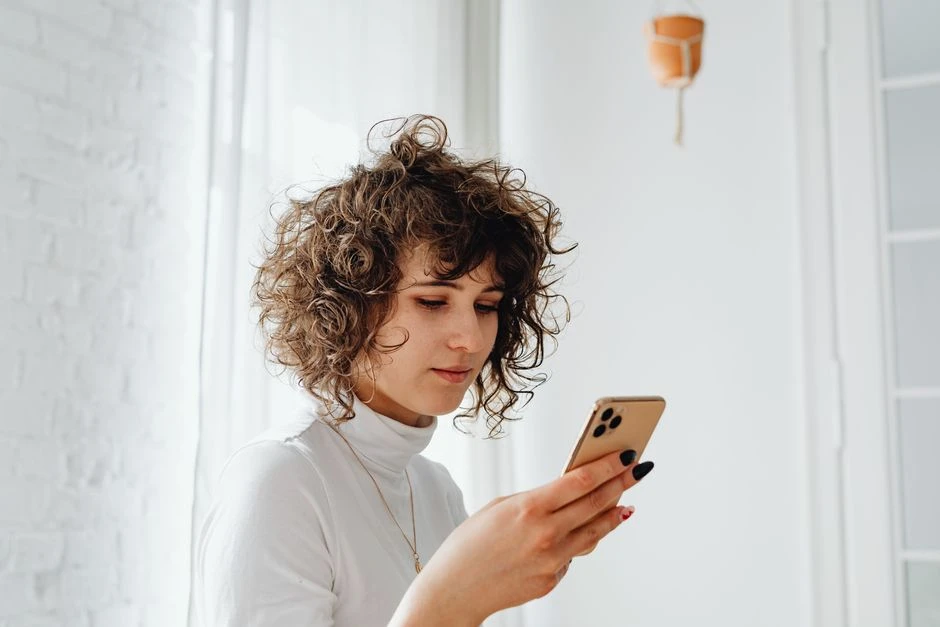 Person looking concerned while reading a phone message