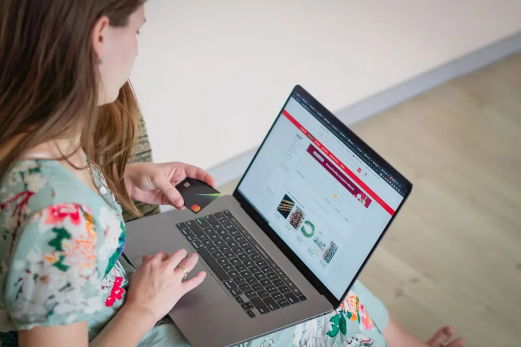 Woman browsing an online shopping website on her laptop at home