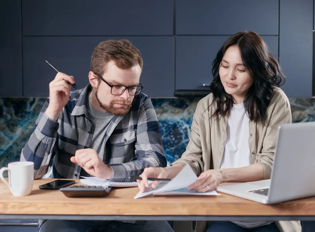 Couple reviewing household bills and finances at home