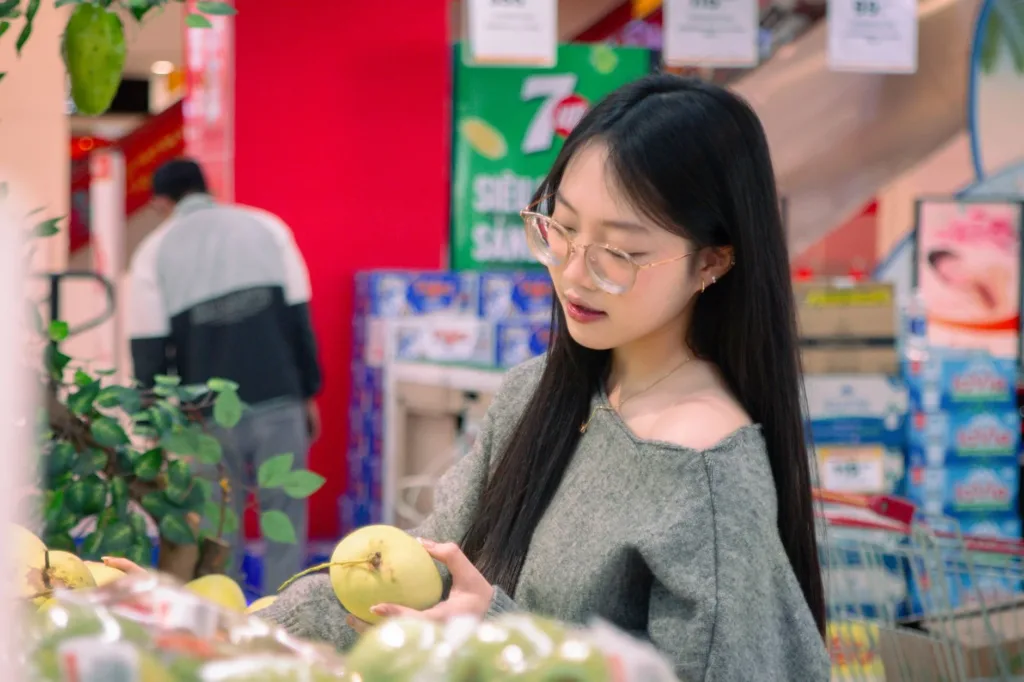 Woman choosing fresh fruit while shopping at a supermarket
