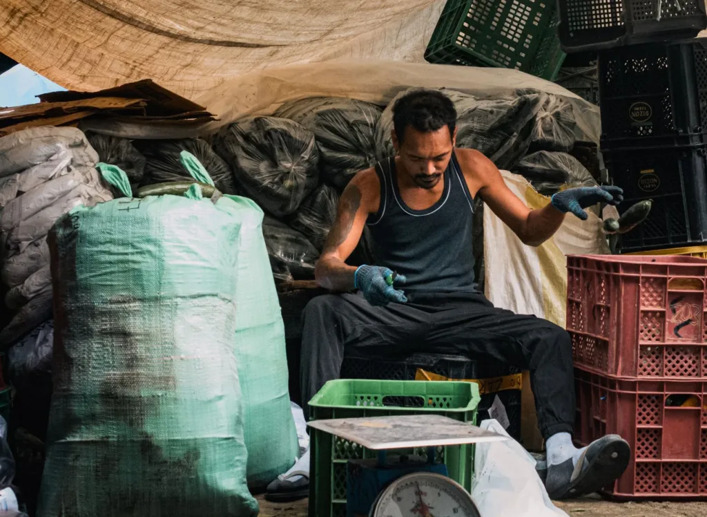 Market vendor at a stall considering a payment app for sales