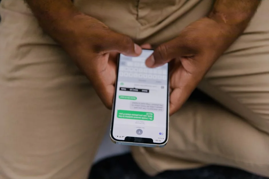 Close-up of hands typing a message on a smartphone screen, reviewing a suspicious offer