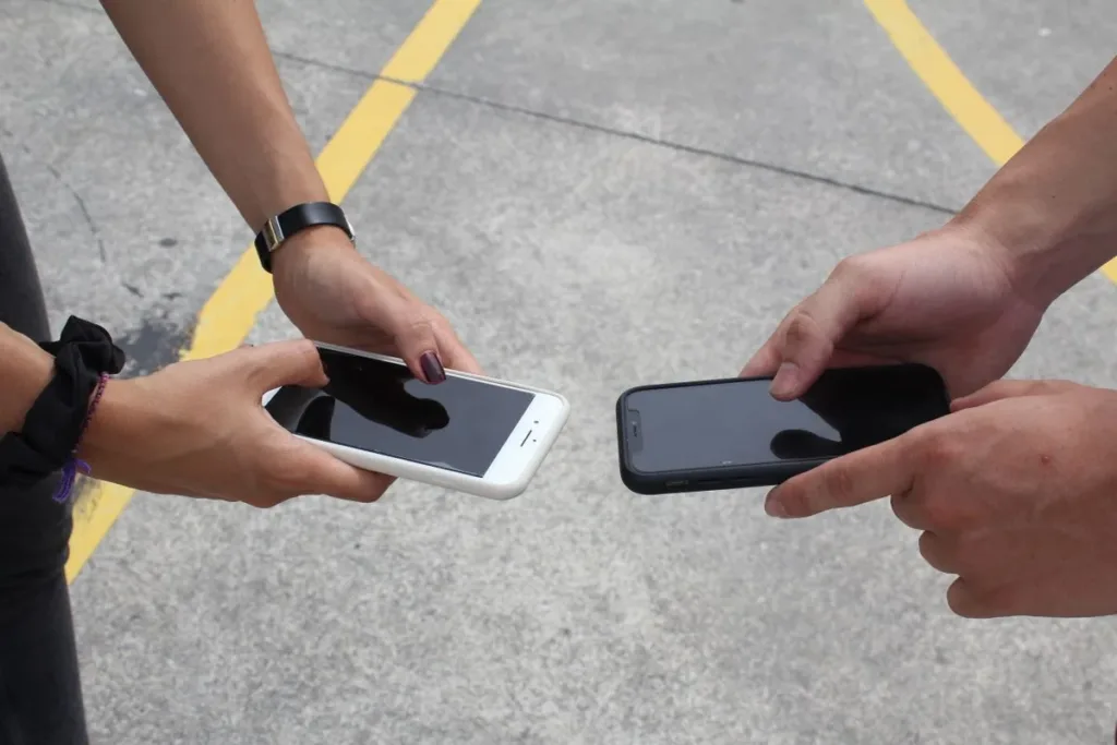 Woman comparing two smartphones