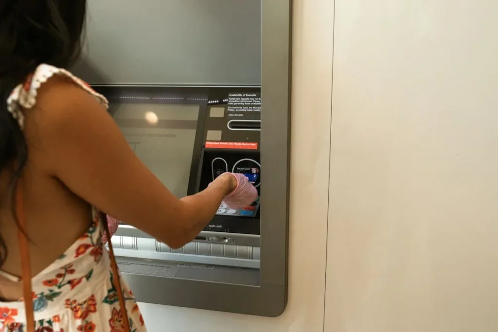 Person using a debit card at a machine
