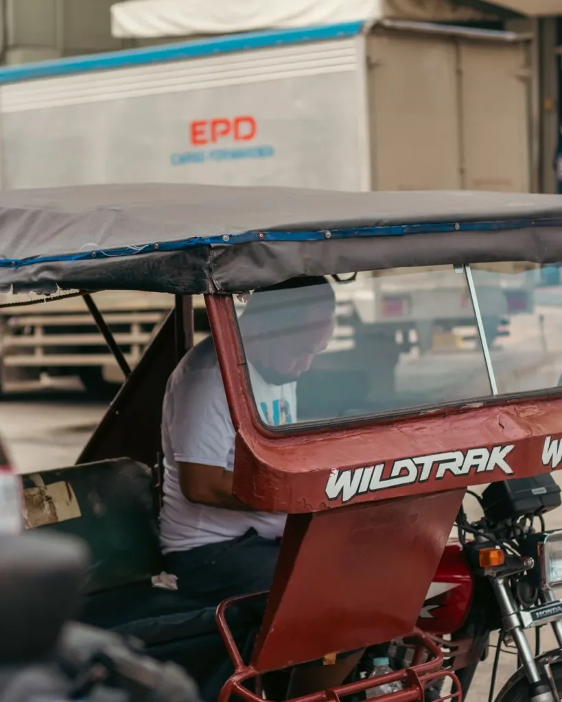 Tricycle driver considering a loan for repairs