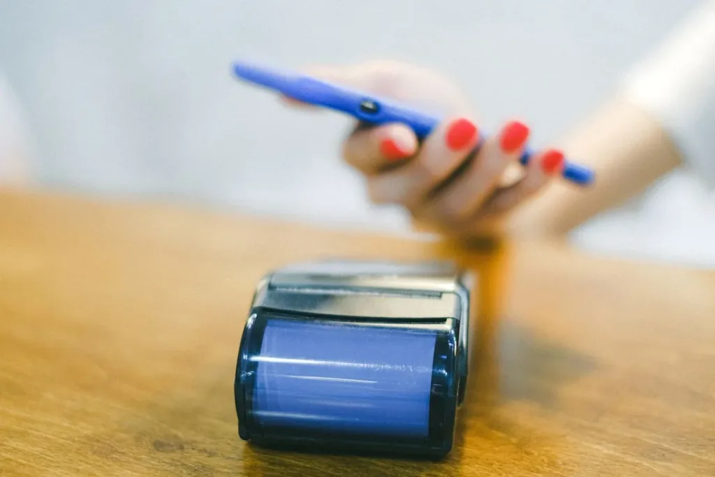 Woman paying with a card using her phone