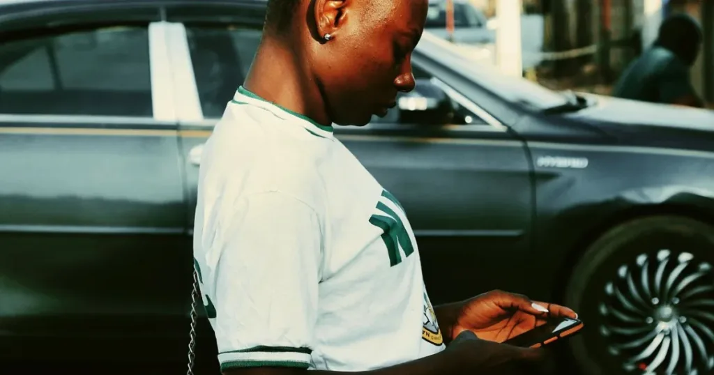 Young Nigerian woman using her smartphone outdoors in Abuja