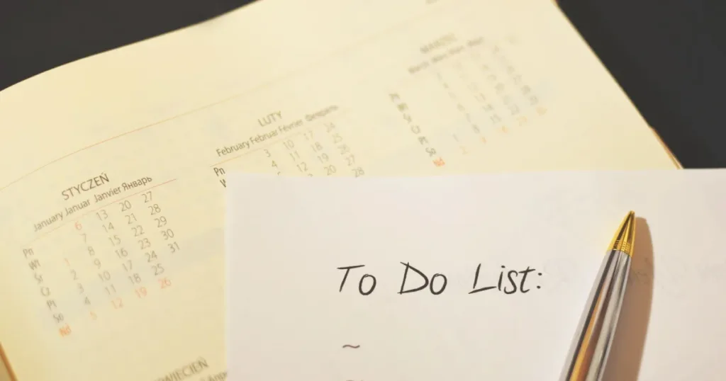 Pen resting on a calendar to-do checklist representing a 30-day plan