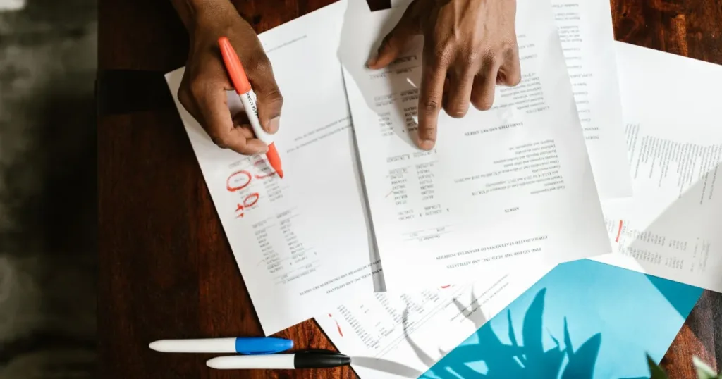 Person reviewing paperwork and documents at home