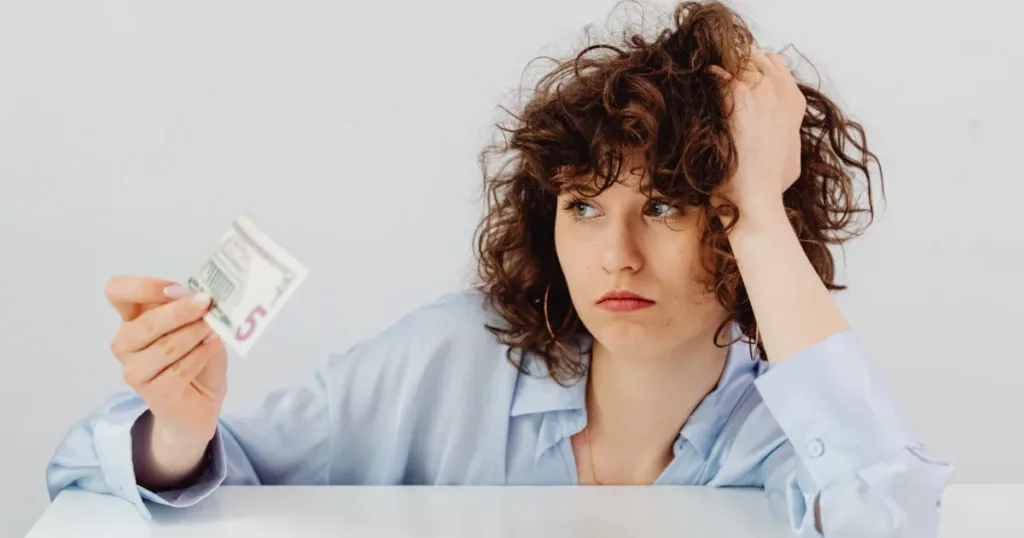 Person reviewing bills and paperwork before applying for a credit card