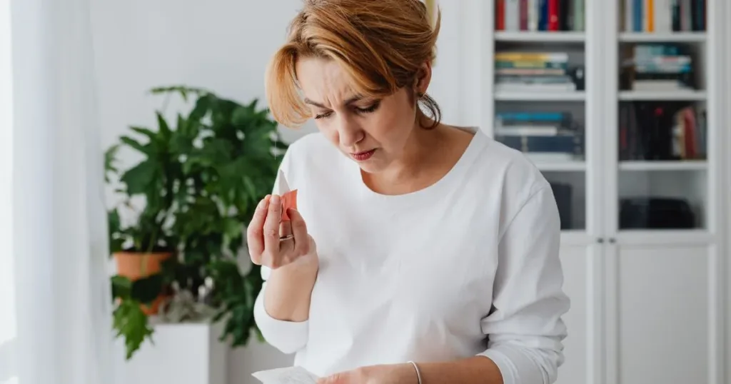 Worried person looking at household bills at home