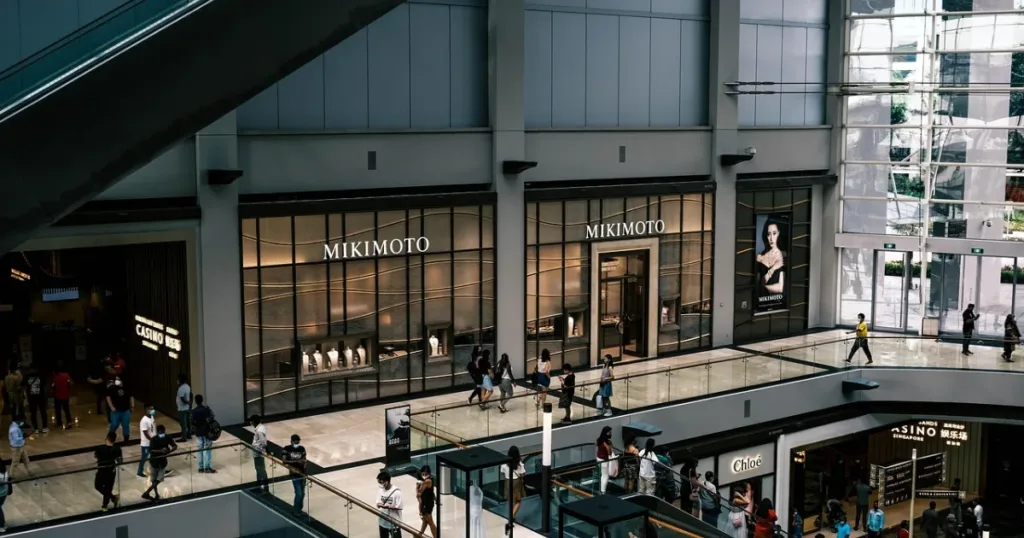 Interior of a busy shopping mall with a crowd of shoppers