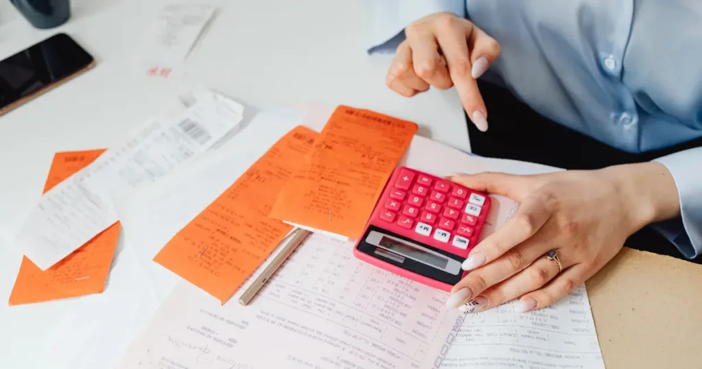 Receipts and calculator laid out for monthly budget planning