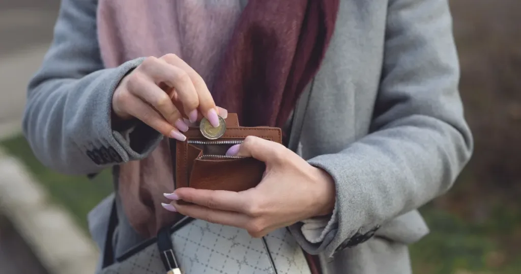Woman checking coins from her wallet