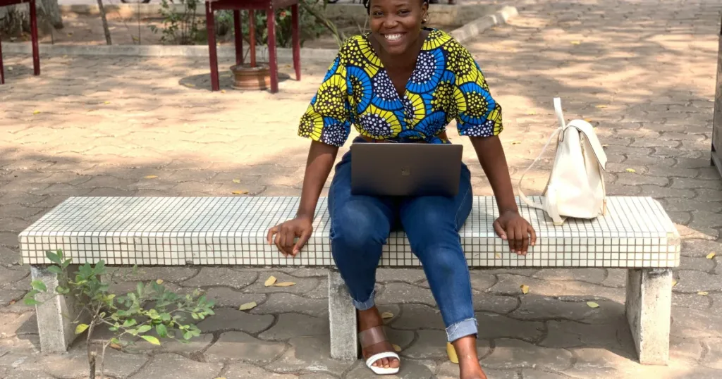 Self-employed South African working outdoors on a laptop
