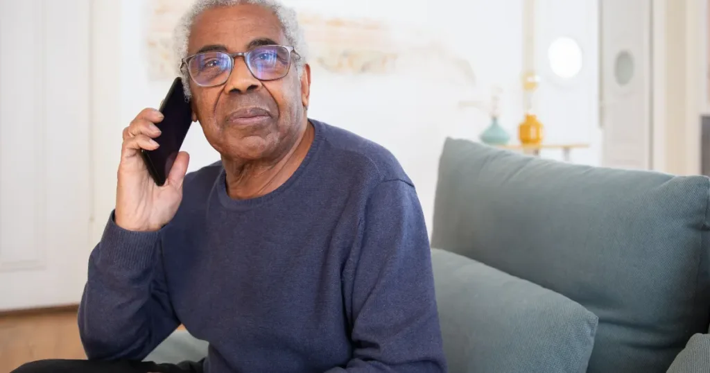 Senior South African on a phone call, illustrating caution around unsolicited pension grant credit offers