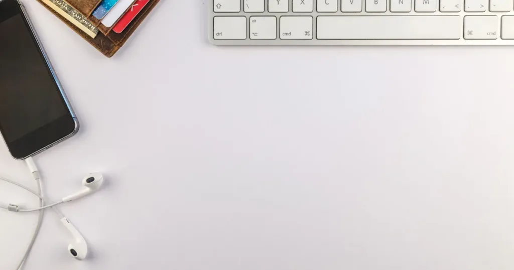 Person holding a credit card while using a laptop, comparing store card and retail credit options