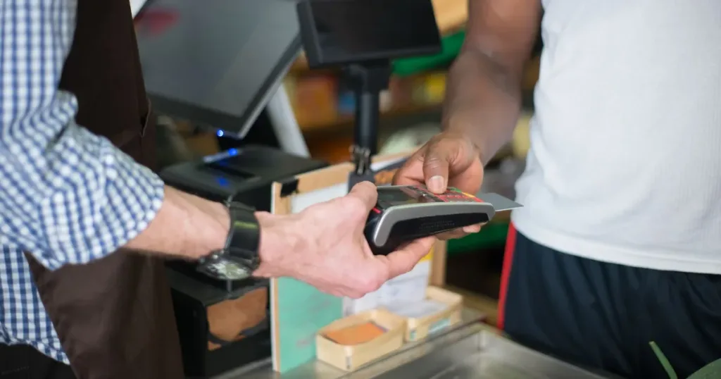 Customer paying with a bank card at a retail counter
