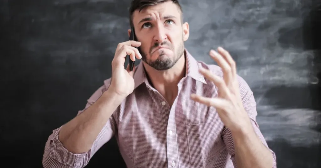 Frustrated man checking a phone with no signal