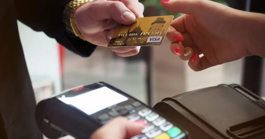 Person paying with a credit card while shopping